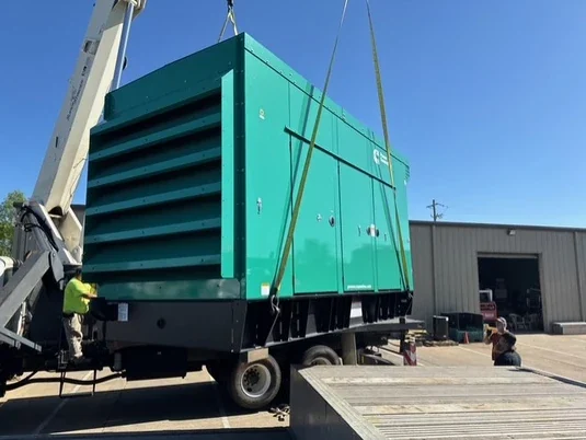 Industrial generator module lifted by crane during coordinated removal